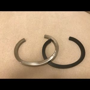 Two narrow “cuff” bracelets